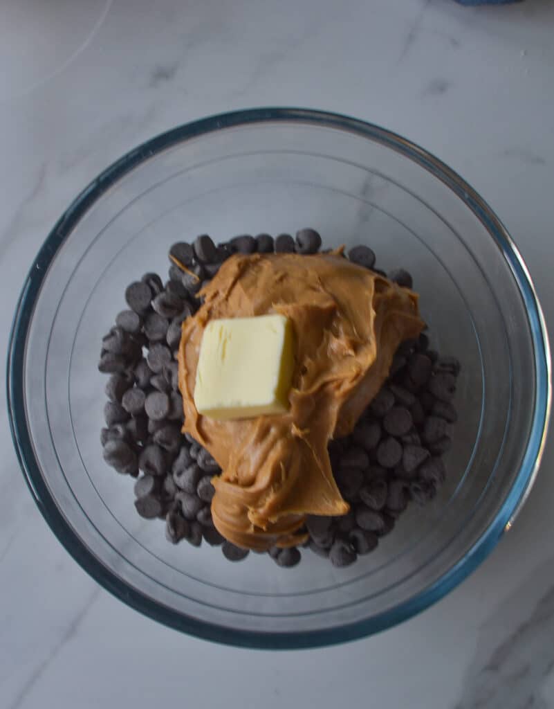 Chocolate chips, peanut butter and butter in a glass bowl