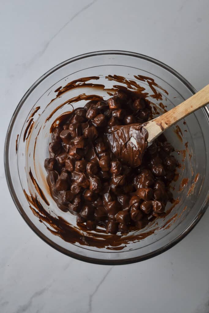 Marshmallows coated with melted chocolate and peanut butter.