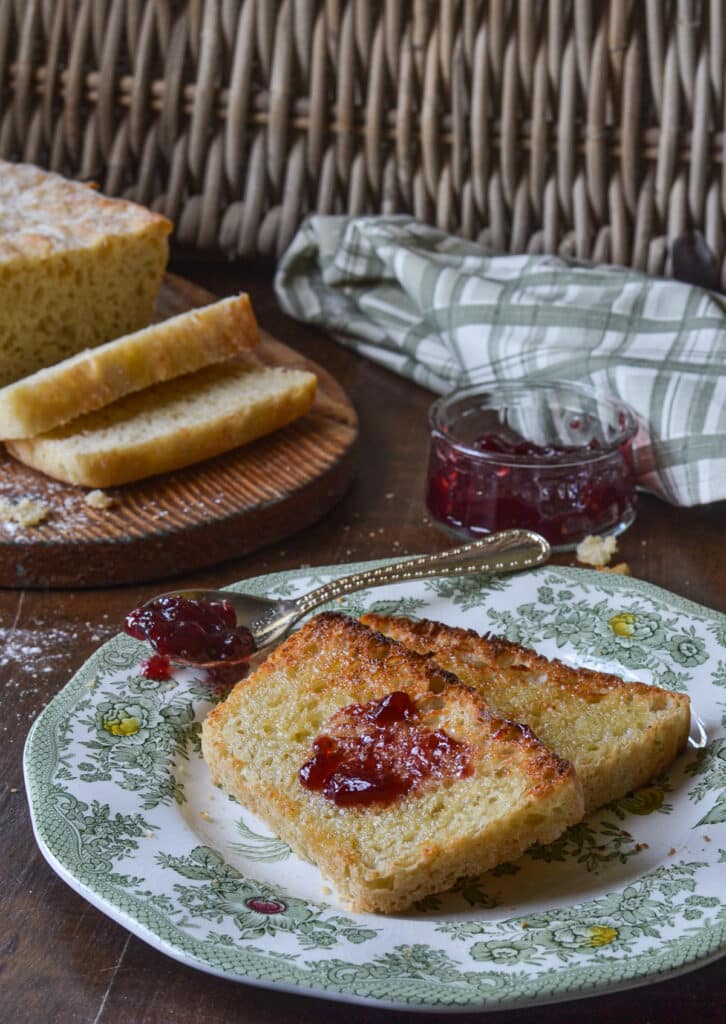 Toasted English Muffin slices with butter and jam.