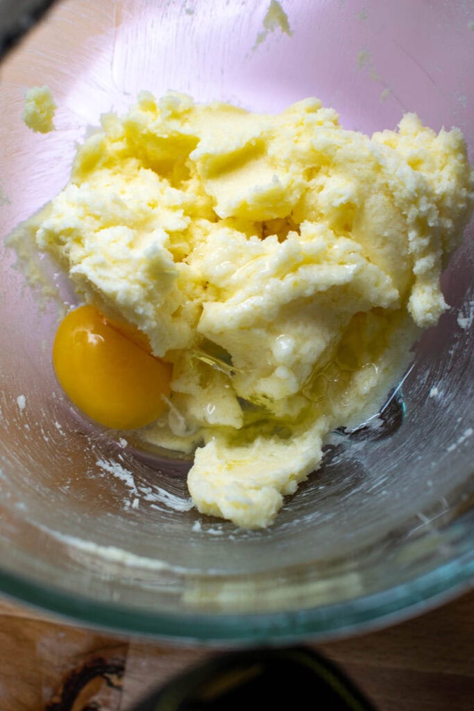 Egg added to the butter and sugar mixture for cupcake batter.