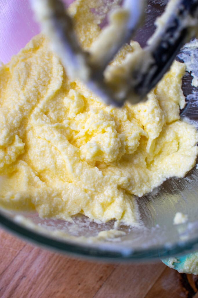 Mixture of butter, sugar, eggs, lemon peel and lemon zest for lemon cupcake batter.