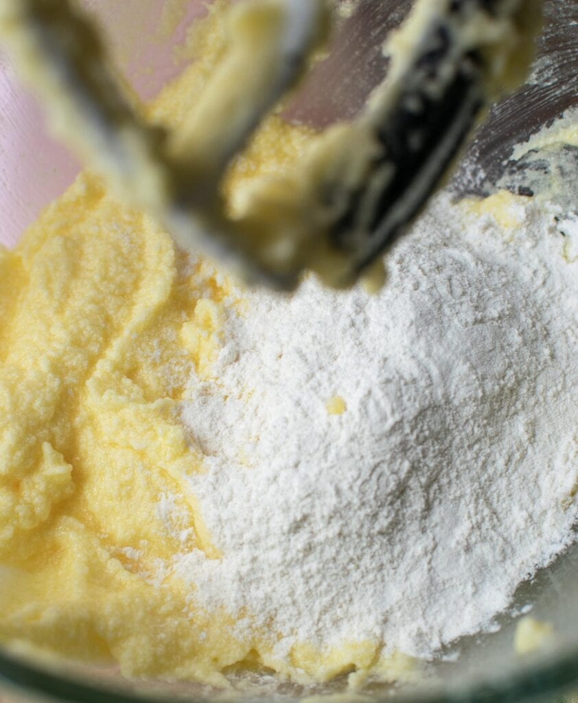 Flour added to butter mixture for lemon cupcakes.