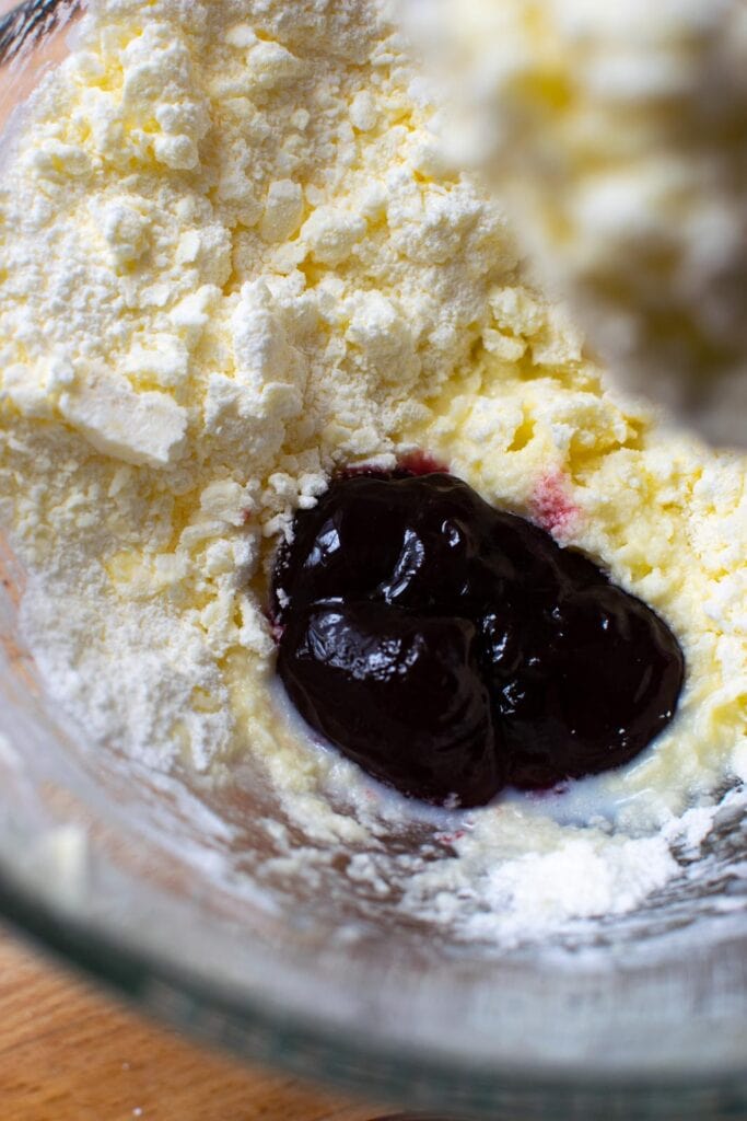 Seedless raspberry jam added to butter and icing sugar mixture for frosting.