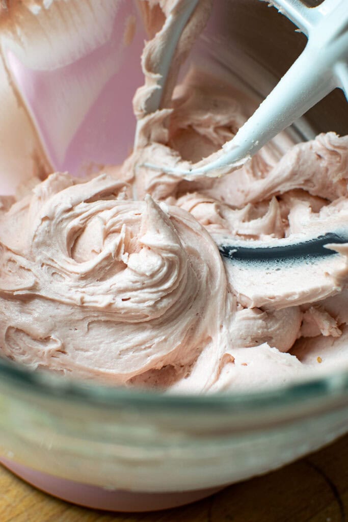 Raspberry buttercream frosting in a mixing bowl to make Pink Lemonade Cupcakes.