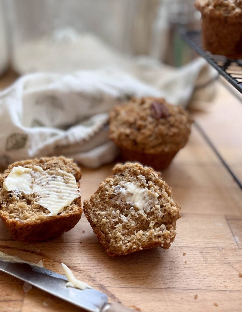 A butter pecan muffin cut in half and buttered.