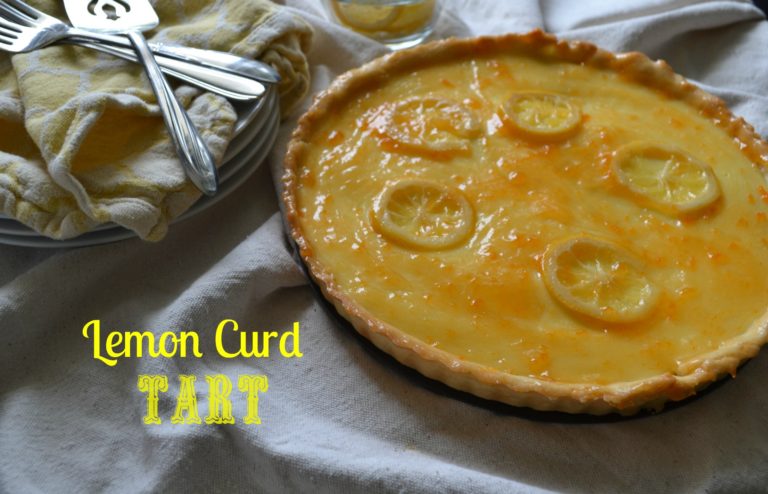 A lemon curd tart topped with fresh lemon slices.