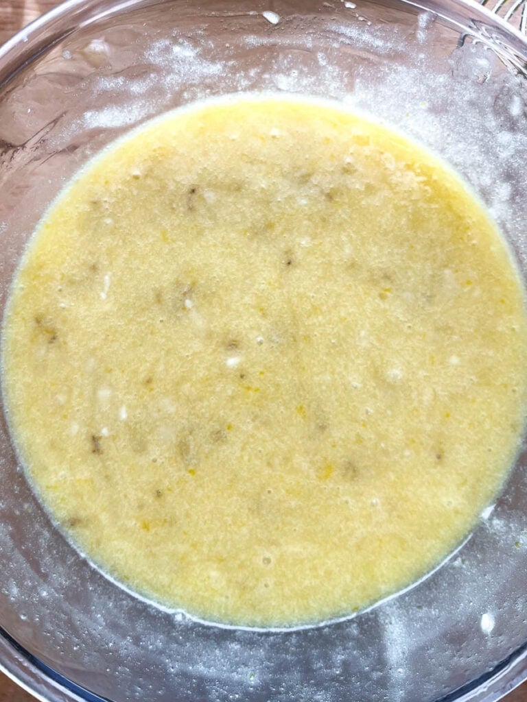 Mashed banana added to the melted butter and sugar mixture and stirred together.