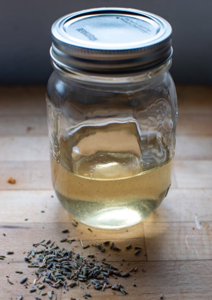 Cooled Lavender simple syrup in a glass Mason Jar.