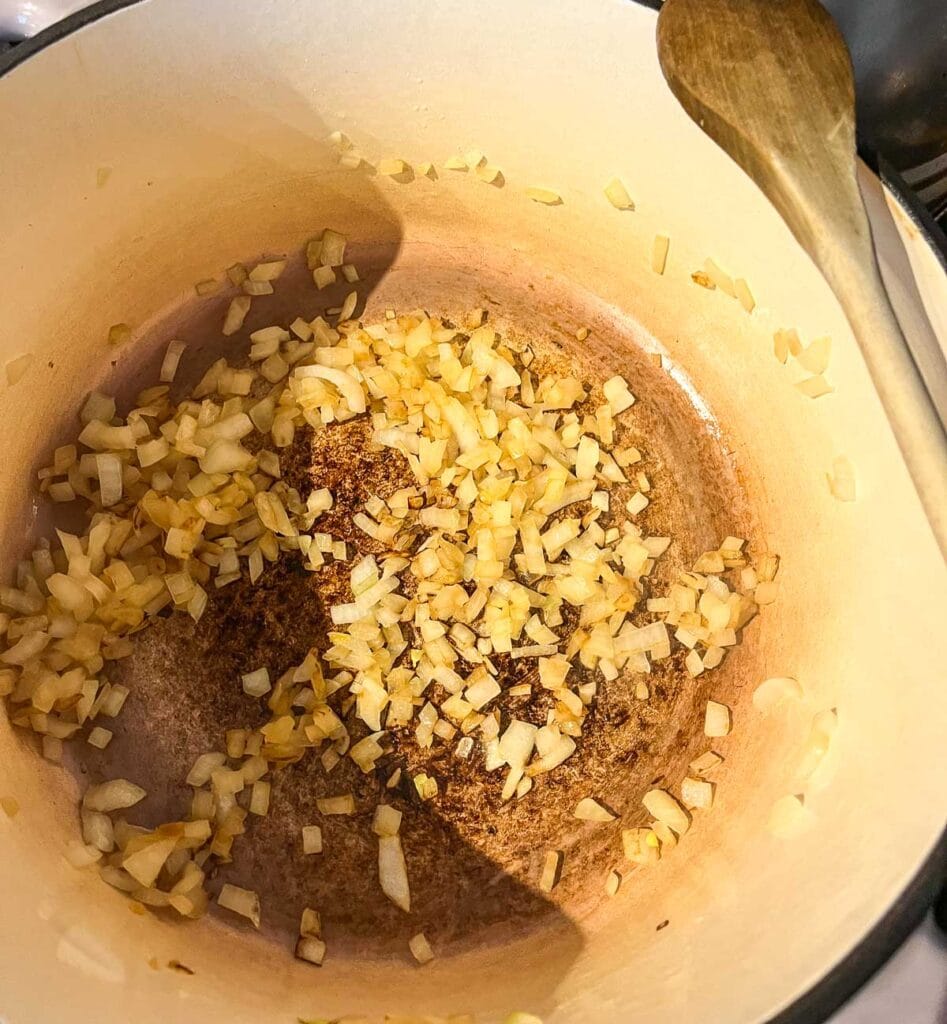Chopped onions cooking in a bit of olive oil in a stock pot.
