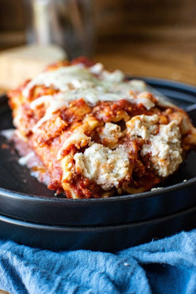 Close up view of manicotti shells filled with cheese and baked.