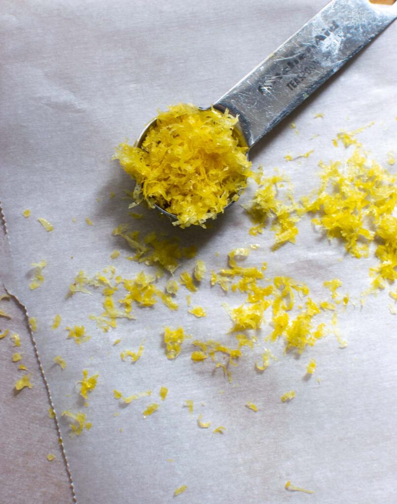 Fresh lemon zest on parchment paper.