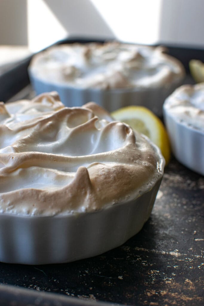 A freshly baked lemon meringue dessert baked without a crust, showing the perfectly browned meringue.