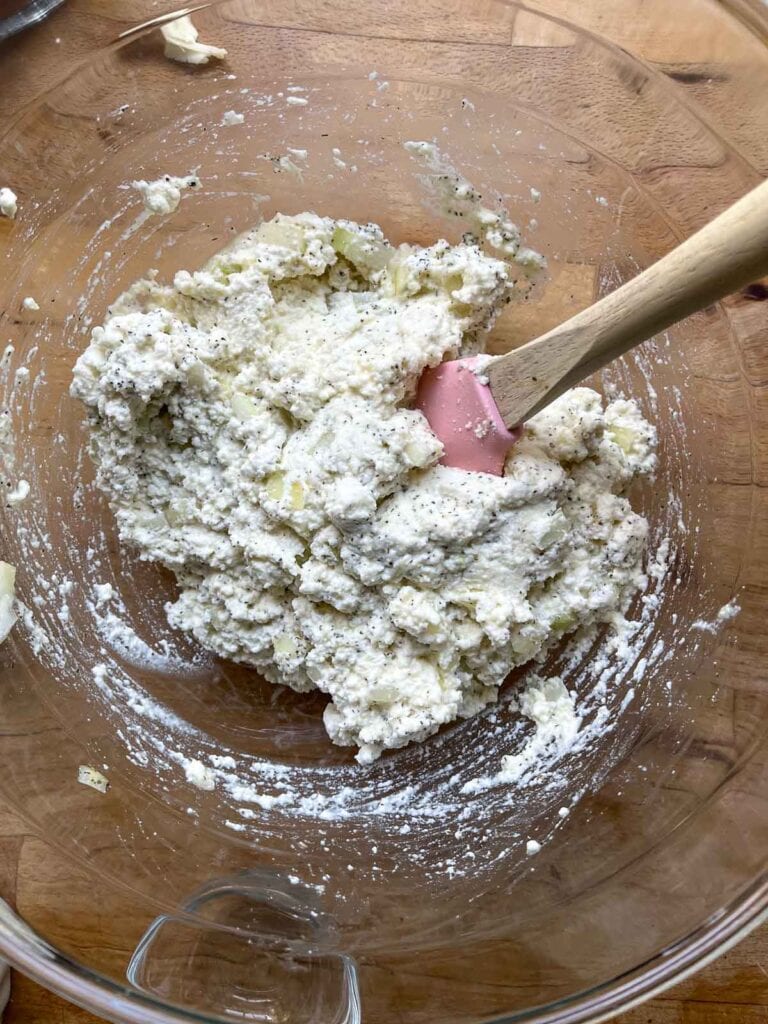 Ricotta cheese mixed with egg, onion and spices for manicotti recipe.