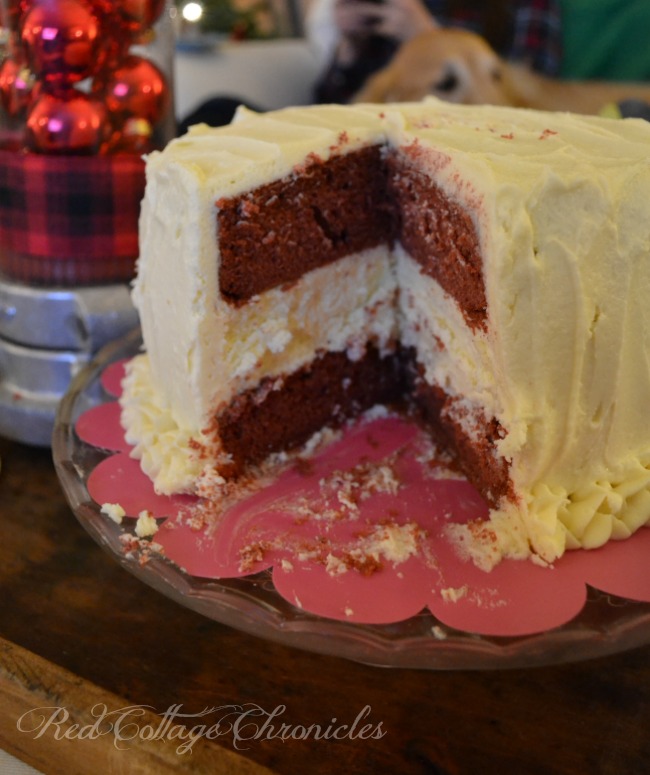 A decadent cheesecake layered between red velvet cake and smothered in a delicious buttercream frosting