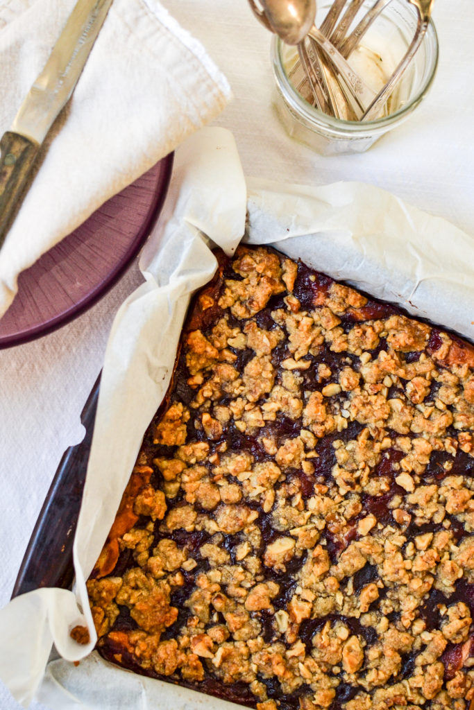 An overhead view of a pan of uncut cranberry cheesecake bars.