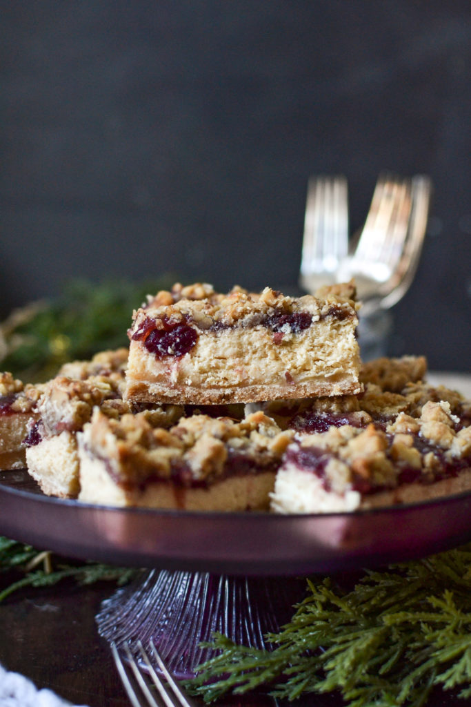 A close up of a cranberry cheesecake bar at eye level.