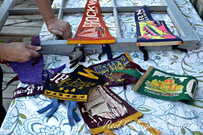 Upcycle challenge uses an old window frame to display an collection of vintage pennants