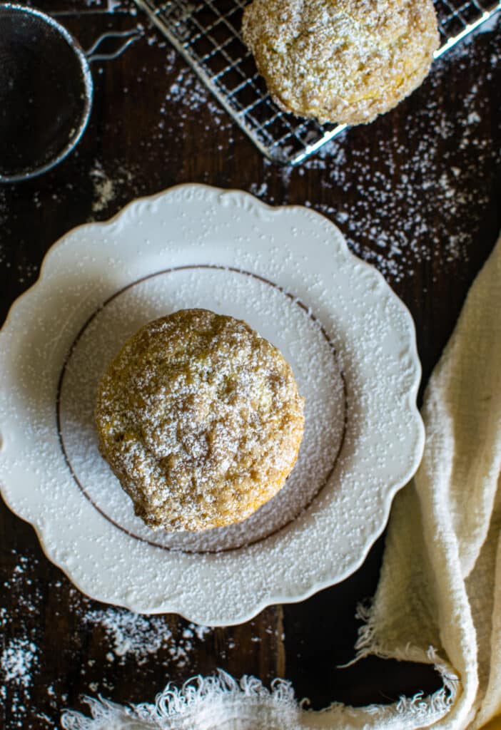 Overhead view of a banana streusel muffin dusted with powdered sugar.