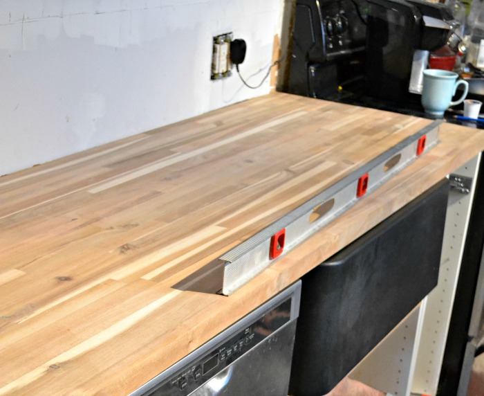 butcher block counter and black farmhouse sink