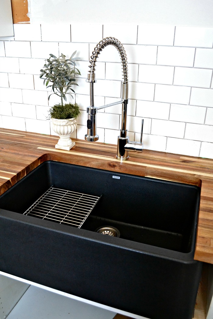 A black farmhouse sink gives our country kitchen a warm feel