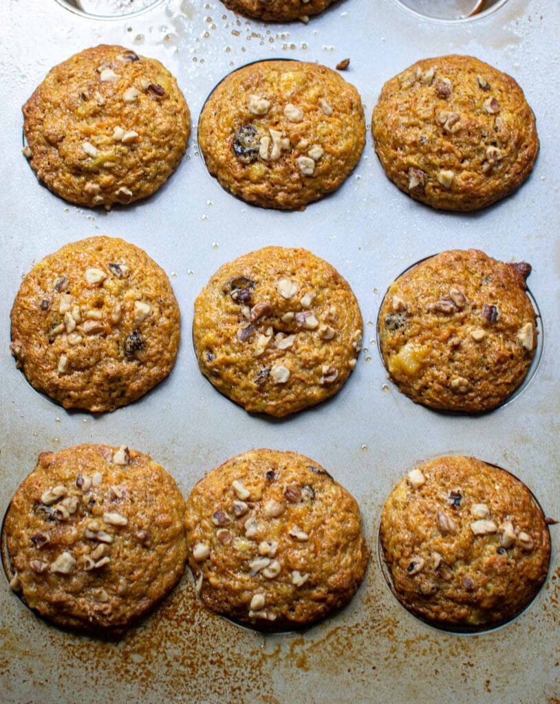 A muffin pan filled with morning glory muffins fresh out of the oven.