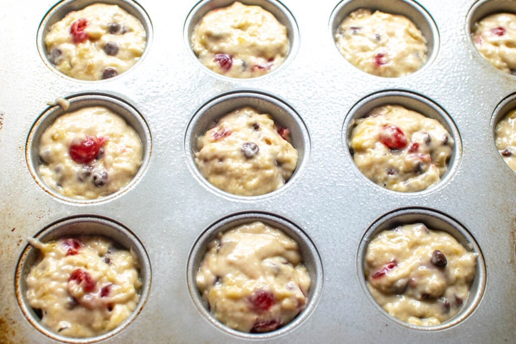 Banana Cherry Chocolate Chip muffin batter in muffin tins before baking.