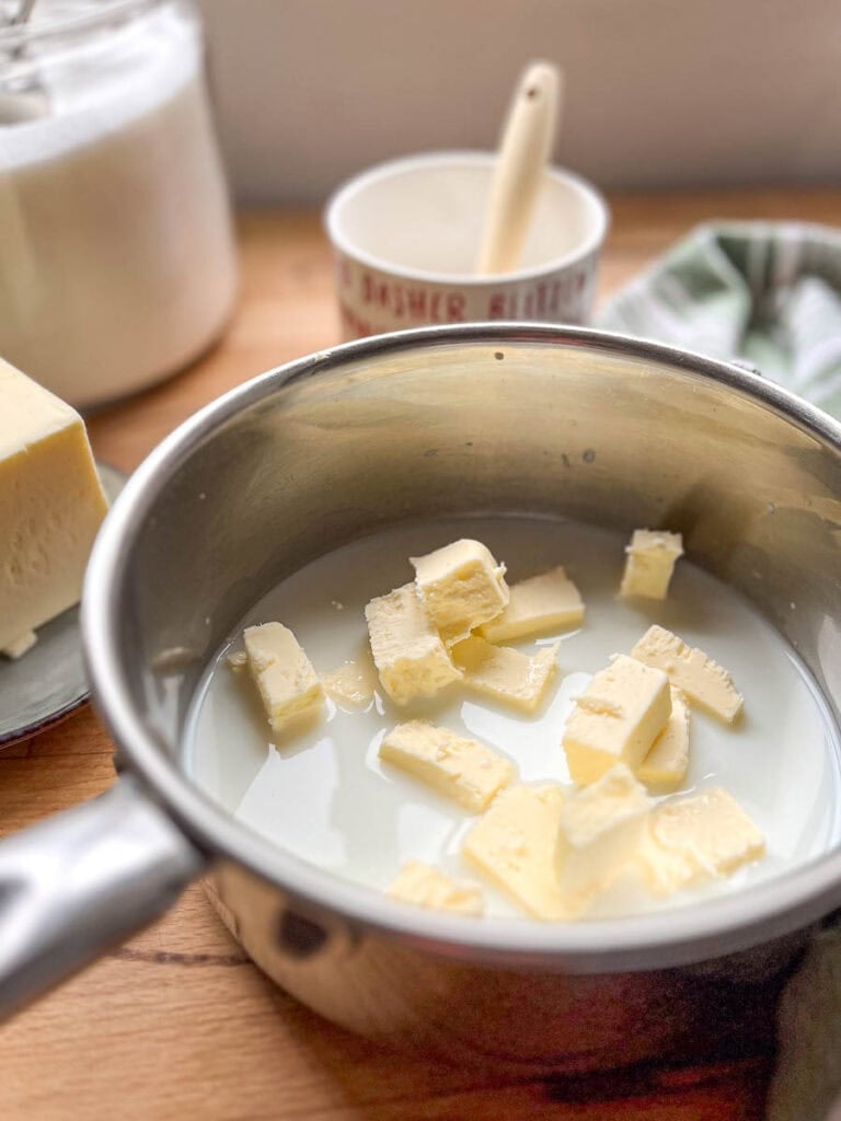 Milk and butter being heated in a sauce pan.