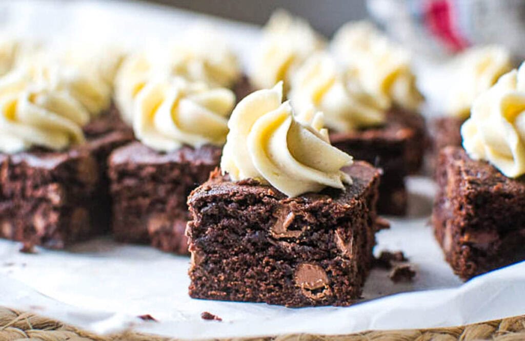Coffee frosted chocolate brownies on a sheet of parchment paper.