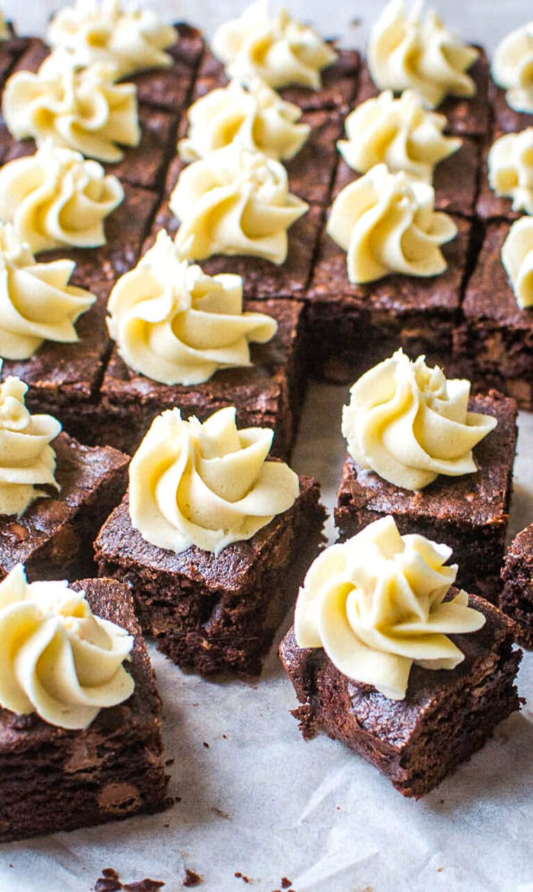 Several squares of chocolate brownies frosted with a swirl of coffee frosting.