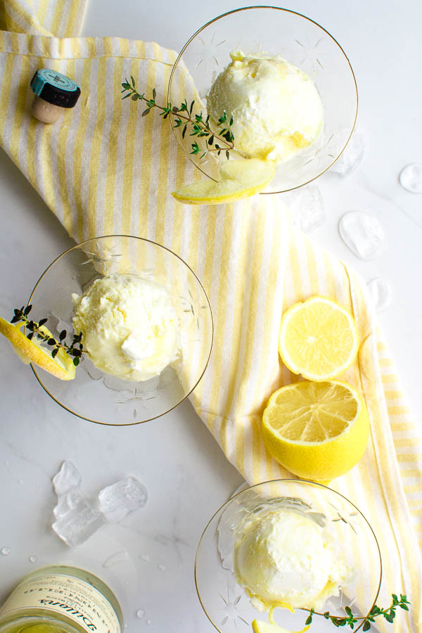 3 cocktail glasses filled with a frozen dessert made with whipping cream, limoncello and lemon curd