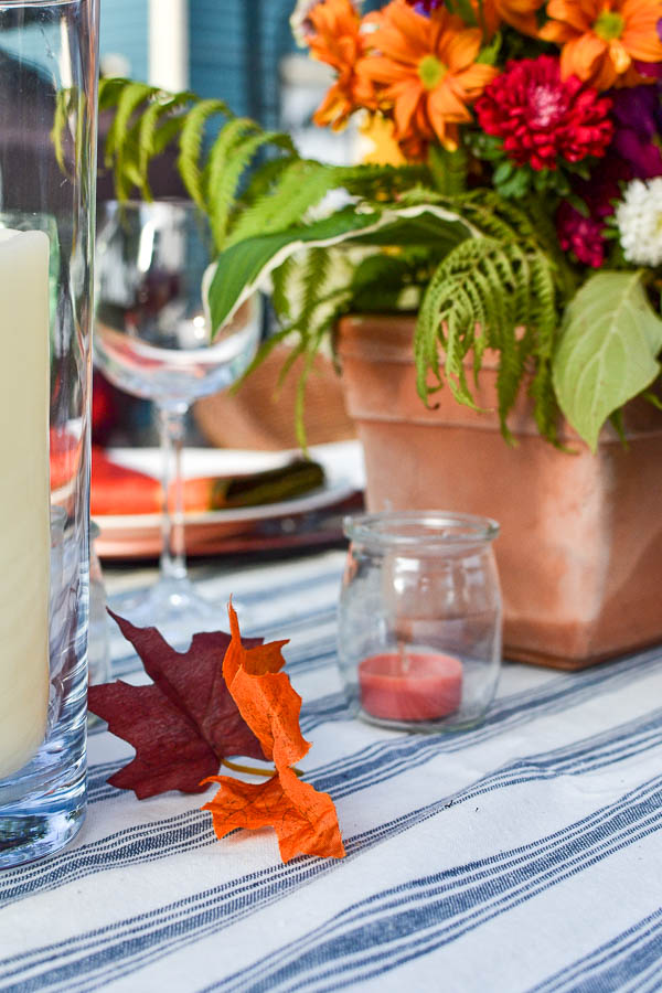 yogurt jars with tealight candles on a dining table