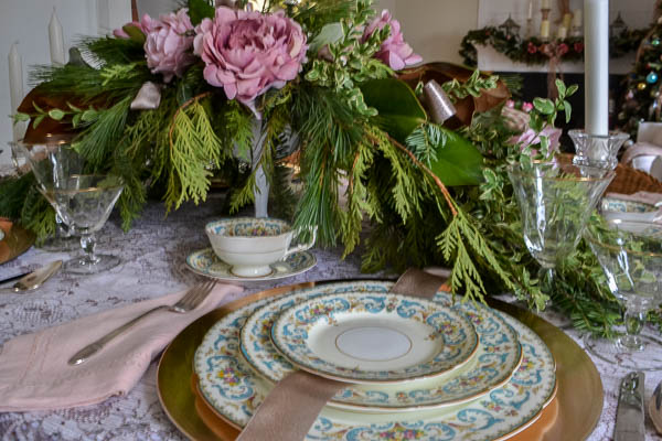 Evergreen Christmas table centerpiece with pink flowers