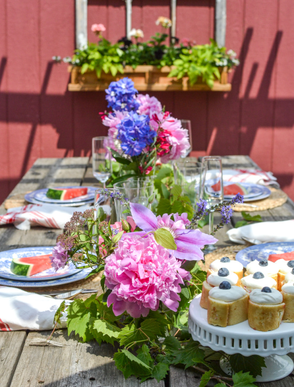 A brightly coloured summer table with fresh garden flowers