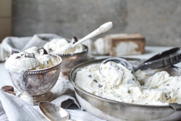 Freshly churned peppermint patty ice cream is scooped into footed ice cream bowls.