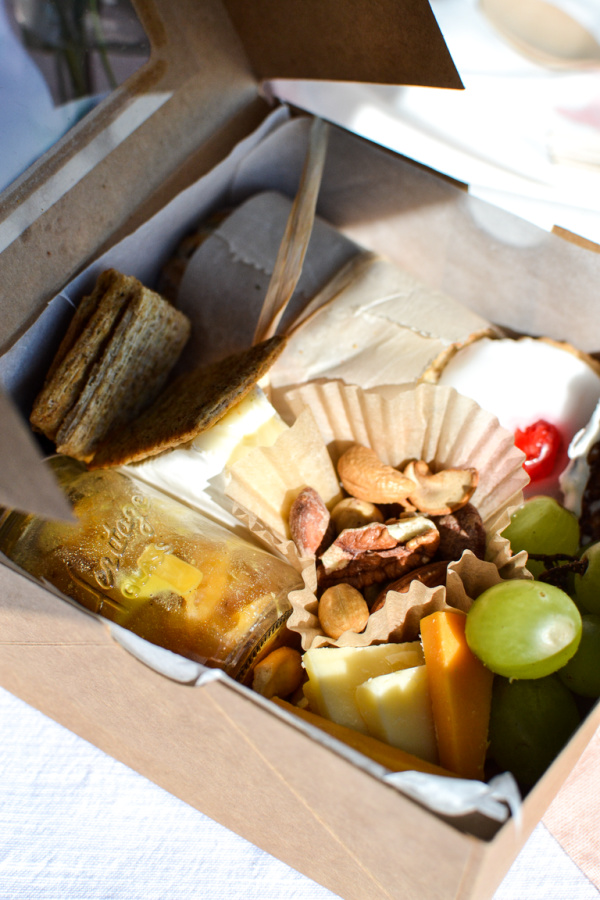 Sandwich, fruit, cheese and crackers in a box