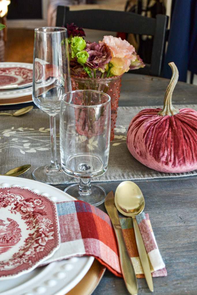 Pink velvet pumpkin accents on an autumn dinner table