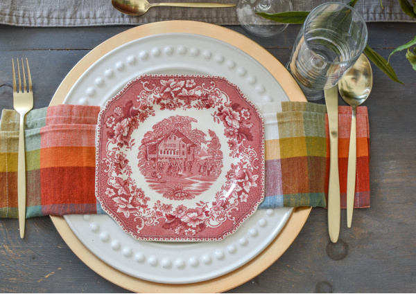 Pink transferware plates paired with plaid napkins create a Cozy Autumn table