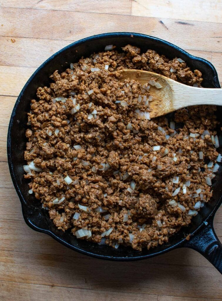 Ground Beef and onions being browned in the frying pan to make an easy taco casserole recipe.