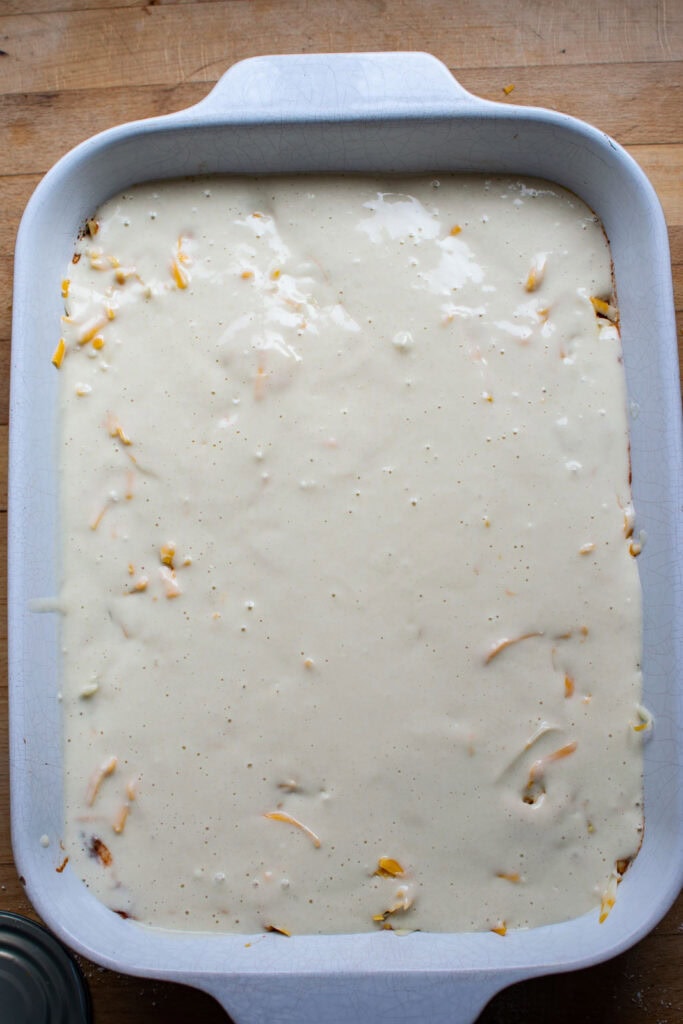 Bisquick batter poured over top of the meat and cheese layers.