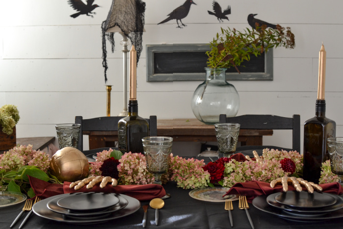 Halloween tablescape in black with burgundy and gold accents