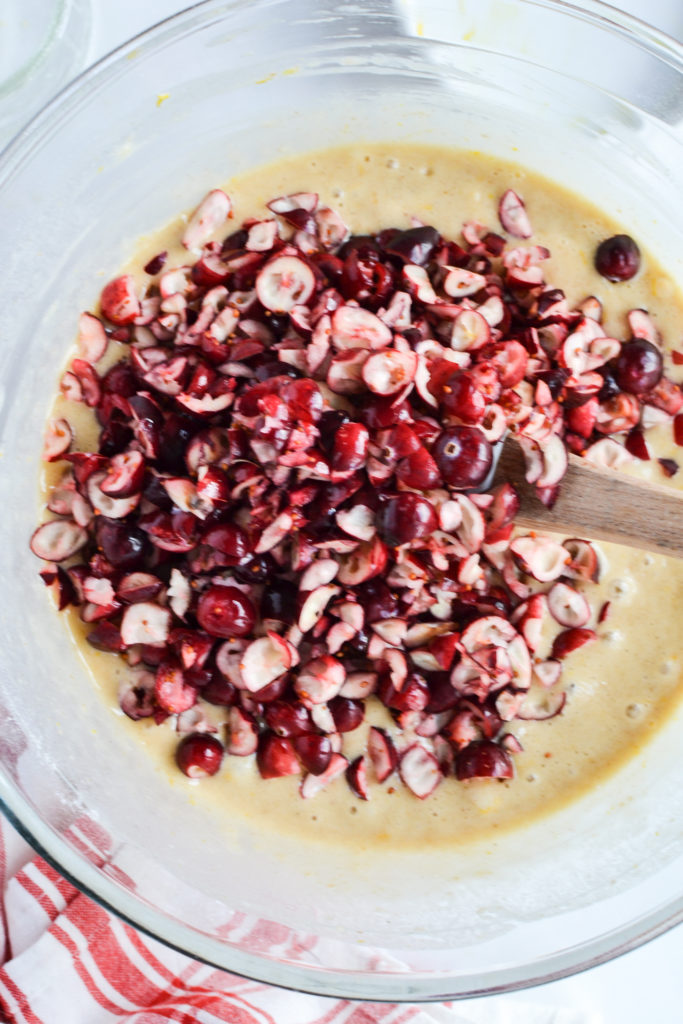 Adding cranberries to batter for orange cranberry loaf