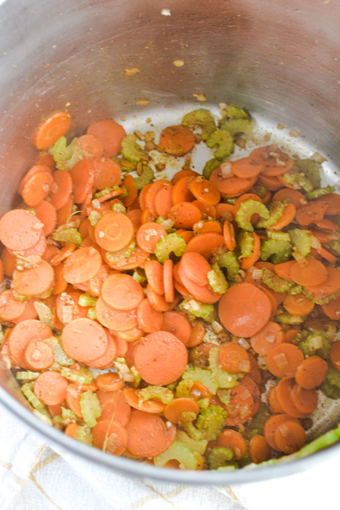 Carrots, Celery, onion, garlic and spices cooking for soup