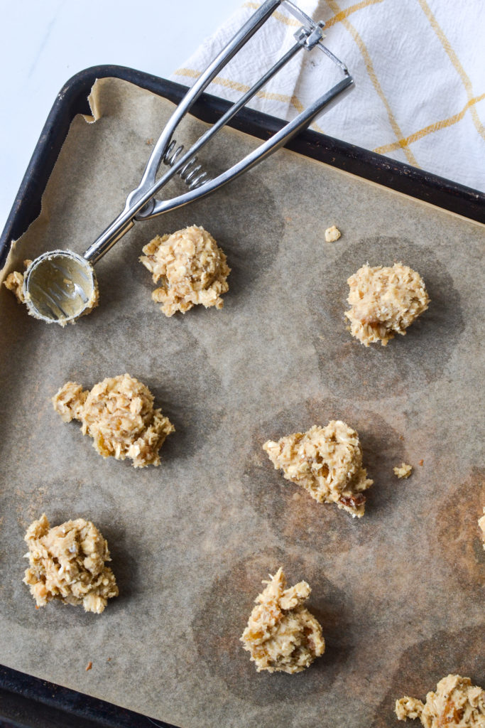 scoops of cookie dough on a baking sheet ready to into the oven