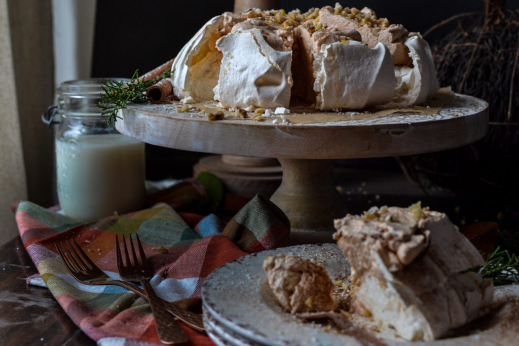 Pavlova with pumpkin cream filling cut into slices