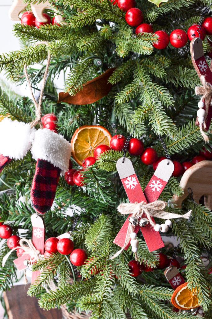 wooden ski and buffalo check mitten Christmas Ornaments on a cozy cabin Christmas tree