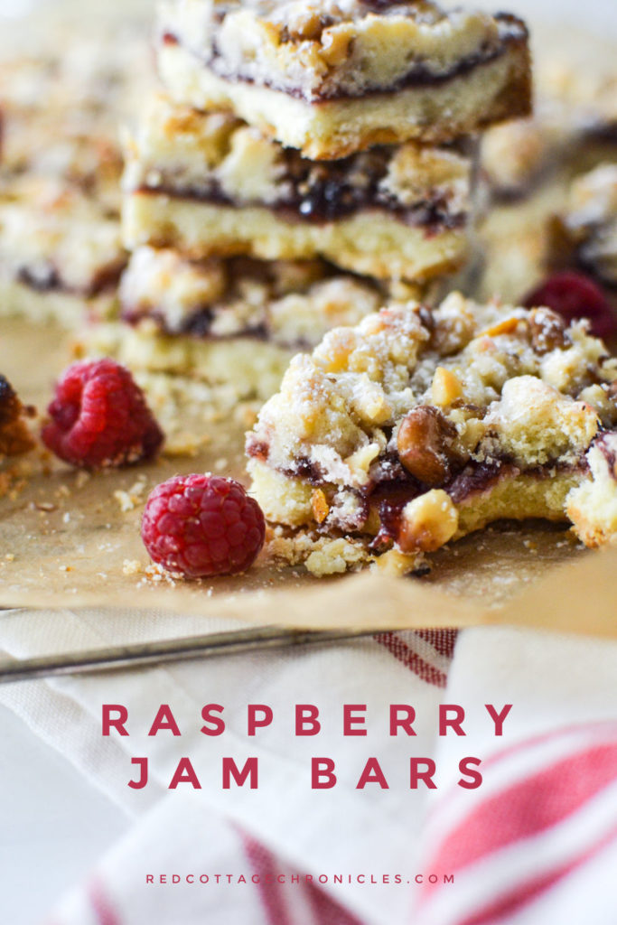 Raspberry jam bars layered on parchment paper