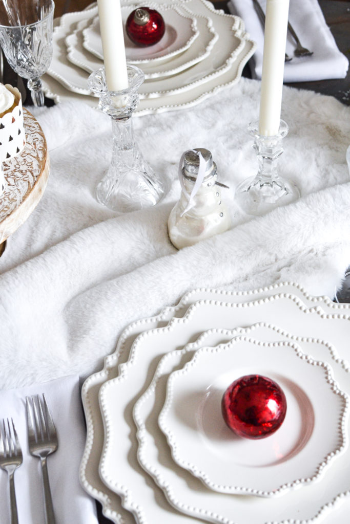 A white Christmas tablescape with a faux fur table runner
