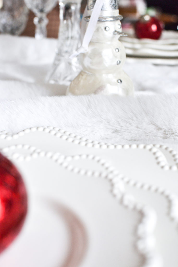 A white glass Snowman Ornament