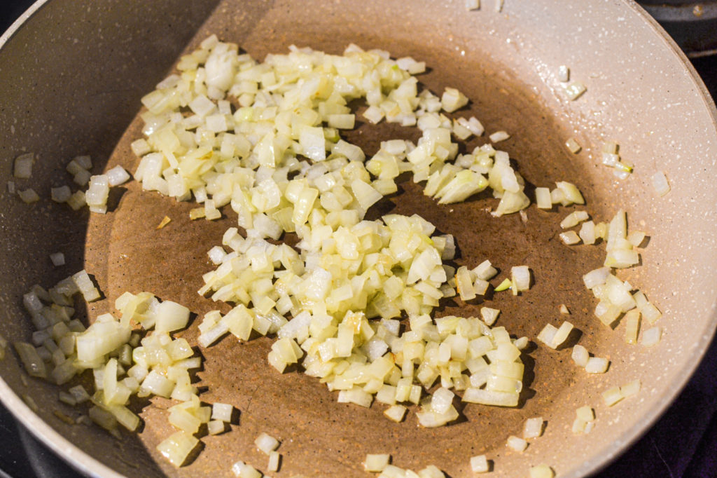 Onions cooked in olive oil is the first step to making a tourtiére