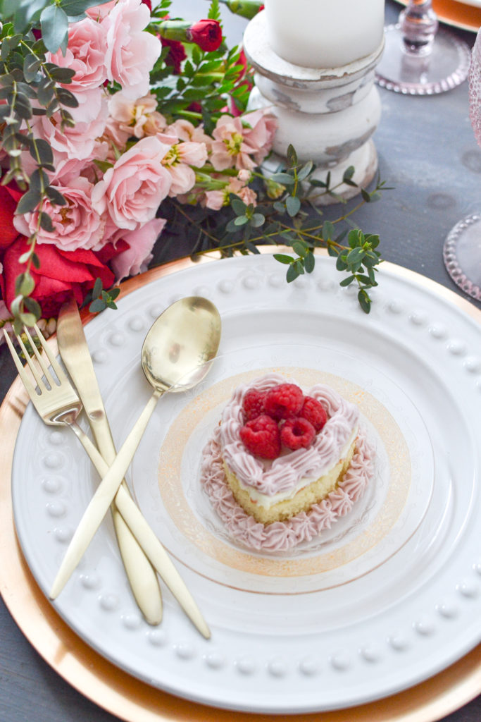 Heart shaped mini cakes with raspberries for a romantic table setting